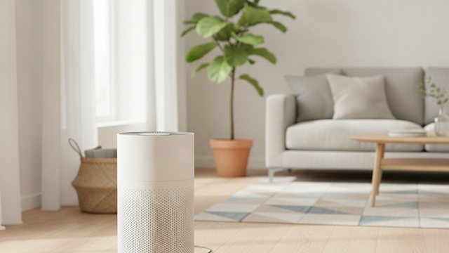 Air purifier running in a bright living room